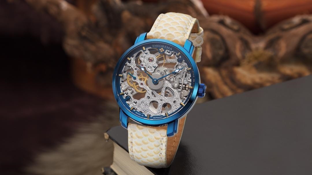 Made in Germany Venezia Theorema GM-118-5 skeleton dial watch with a blue case and cream fish pattern leather band