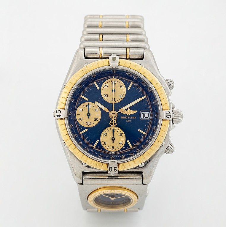 Breitling Chronomat UTC GMT watch for men with a blue dial, yellow sub-dials, yellow bezel, date windoe and a silver bracelet